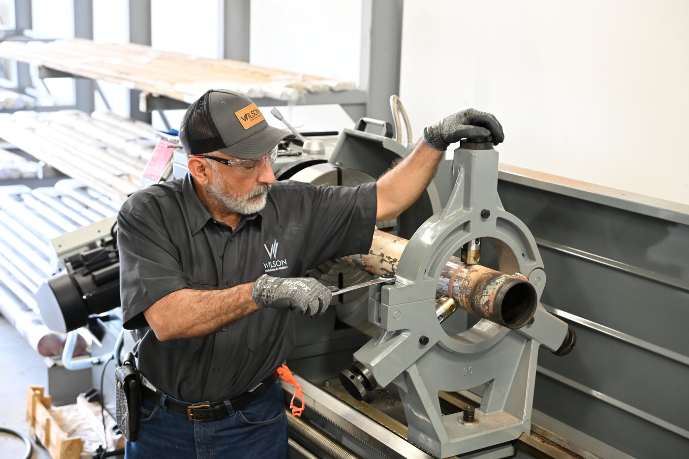 Wilson team member setting up a cylinder component on the shop lathe